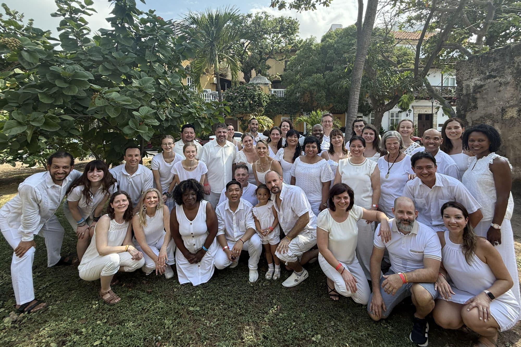 Alumni of the program reunited years later, dressed in white at a gathering in Colombia.